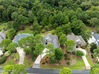 Nestled on a quiet tree-lined street, this custom-built home on Members Club At St. James Plantation in North Carolina - for sale on GolfHomes.com, golf home, golf lot
