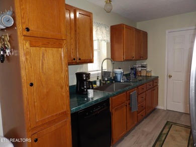 Well-maintained property featuring a 14' RV carport with hookups on Lake Tansi Village Country Club in Tennessee - for sale on GolfHomes.com, golf home, golf lot