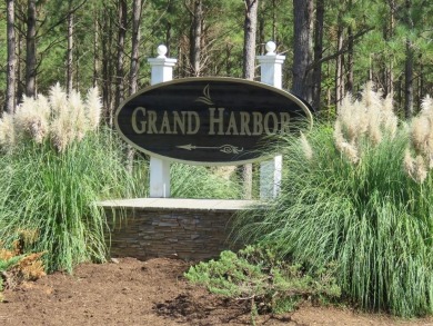 Build your dream home on this level wooded home site overlooking on The Patriot Golf Club At Grand Harbor in South Carolina - for sale on GolfHomes.com, golf home, golf lot