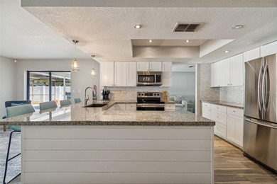 Welcome to this beautifully maintained 3-bedroom, 2-bath pool on Oak Hills Country Club in Florida - for sale on GolfHomes.com, golf home, golf lot