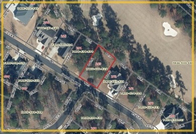 Build your dream home on this level wooded home site overlooking on The Patriot Golf Club At Grand Harbor in South Carolina - for sale on GolfHomes.com, golf home, golf lot