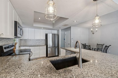 Welcome to this beautifully maintained 3-bedroom, 2-bath pool on Oak Hills Country Club in Florida - for sale on GolfHomes.com, golf home, golf lot