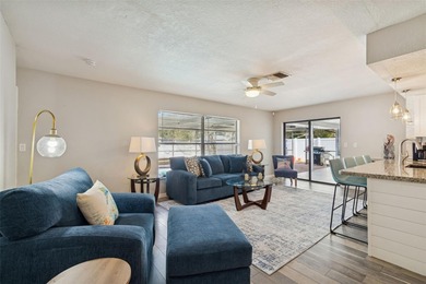 Welcome to this beautifully maintained 3-bedroom, 2-bath pool on Oak Hills Country Club in Florida - for sale on GolfHomes.com, golf home, golf lot