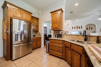 BEAUTIFUL STONE AND BRICK HOME on the par 3, 14th hole of the on Pecan Plantation Country Club in Texas - for sale on GolfHomes.com, golf home, golf lot