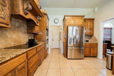 BEAUTIFUL STONE AND BRICK HOME on the par 3, 14th hole of the on Pecan Plantation Country Club in Texas - for sale on GolfHomes.com, golf home, golf lot