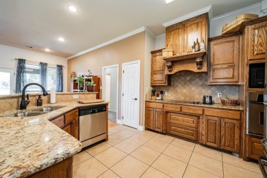BEAUTIFUL STONE AND BRICK HOME on the par 3, 14th hole of the on Pecan Plantation Country Club in Texas - for sale on GolfHomes.com, golf home, golf lot