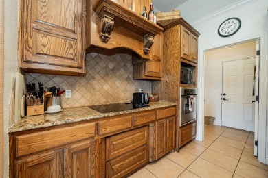 BEAUTIFUL STONE AND BRICK HOME on the par 3, 14th hole of the on Pecan Plantation Country Club in Texas - for sale on GolfHomes.com, golf home, golf lot
