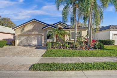 This spacious 1-story home offers serene water views from nearly on Woodmont Country Club in Florida - for sale on GolfHomes.com, golf home, golf lot
