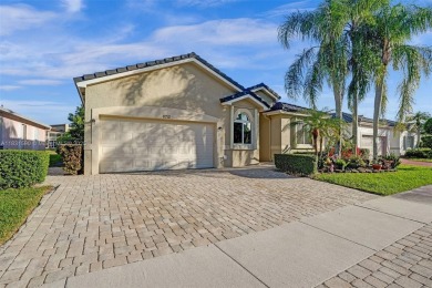 This spacious 1-story home offers serene water views from nearly on Woodmont Country Club in Florida - for sale on GolfHomes.com, golf home, golf lot