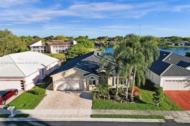 This spacious 1-story home offers serene water views from nearly on Woodmont Country Club in Florida - for sale on GolfHomes.com, golf home, golf lot