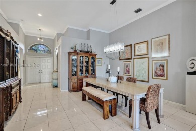 This spacious 1-story home offers serene water views from nearly on Woodmont Country Club in Florida - for sale on GolfHomes.com, golf home, golf lot
