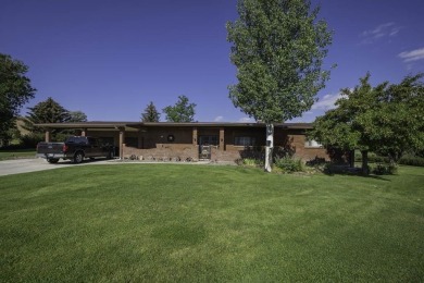 Step into this charming, expansive one-story brick home nestled on Olive Glenn Golf and Country Club in Wyoming - for sale on GolfHomes.com, golf home, golf lot