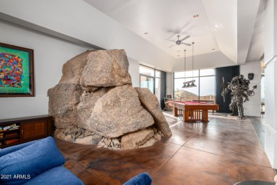 Set among giant boulders outside & inside the home, this on Desert Mountain - Outlaw Golf Course in Arizona - for sale on GolfHomes.com, golf home, golf lot