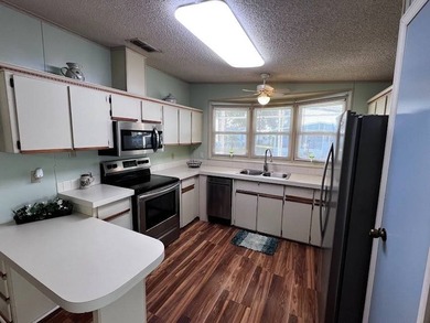 This 2-bedroom, 2-bath home offers 1,296 sq ft of comfortable on Lake Henry Golf Club in Florida - for sale on GolfHomes.com, golf home, golf lot