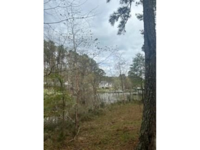 Build your dream home on this level wooded home site located at on The Patriot Golf Club At Grand Harbor in South Carolina - for sale on GolfHomes.com, golf home, golf lot