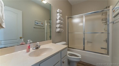 Enjoy incredible lake views from this spacious 4-bedroom, 3-bath on Tan-Tar-A Golf Club in Missouri - for sale on GolfHomes.com, golf home, golf lot