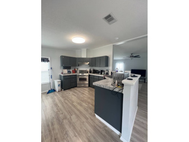 Charming Updated and Modern home with privacy and stunning water on Lake Henry Golf Club in Florida - for sale on GolfHomes.com, golf home, golf lot