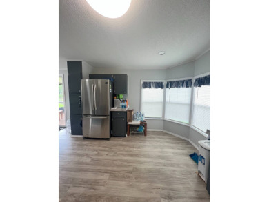Charming Updated and Modern home with privacy and stunning water on Lake Henry Golf Club in Florida - for sale on GolfHomes.com, golf home, golf lot