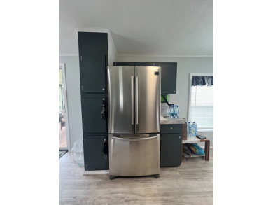 Charming Updated and Modern home with privacy and stunning water on Lake Henry Golf Club in Florida - for sale on GolfHomes.com, golf home, golf lot