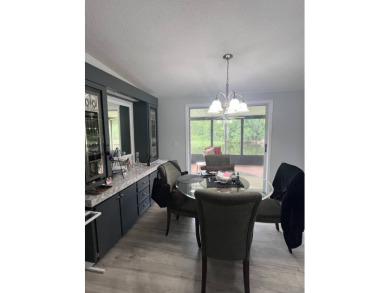 Charming Updated and Modern home with privacy and stunning water on Lake Henry Golf Club in Florida - for sale on GolfHomes.com, golf home, golf lot