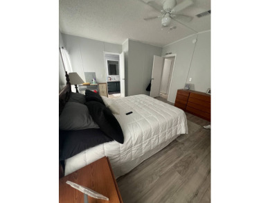 Charming Updated and Modern home with privacy and stunning water on Lake Henry Golf Club in Florida - for sale on GolfHomes.com, golf home, golf lot