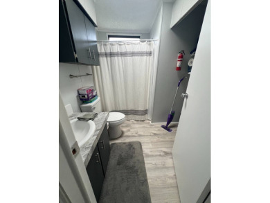 Charming Updated and Modern home with privacy and stunning water on Lake Henry Golf Club in Florida - for sale on GolfHomes.com, golf home, golf lot