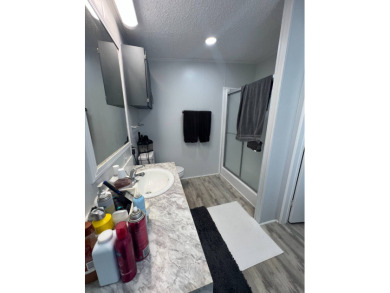 Charming Updated and Modern home with privacy and stunning water on Lake Henry Golf Club in Florida - for sale on GolfHomes.com, golf home, golf lot