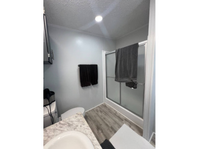 Charming Updated and Modern home with privacy and stunning water on Lake Henry Golf Club in Florida - for sale on GolfHomes.com, golf home, golf lot