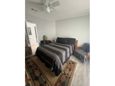 Charming Updated and Modern home with privacy and stunning water on Lake Henry Golf Club in Florida - for sale on GolfHomes.com, golf home, golf lot