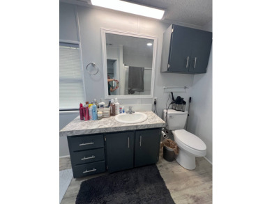 Charming Updated and Modern home with privacy and stunning water on Lake Henry Golf Club in Florida - for sale on GolfHomes.com, golf home, golf lot