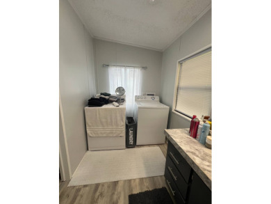 Charming Updated and Modern home with privacy and stunning water on Lake Henry Golf Club in Florida - for sale on GolfHomes.com, golf home, golf lot