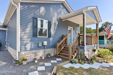 Welcome to this charming 2-bedroom, 2-bath home located just a on Oyster Bay Golf Links in North Carolina - for sale on GolfHomes.com, golf home, golf lot