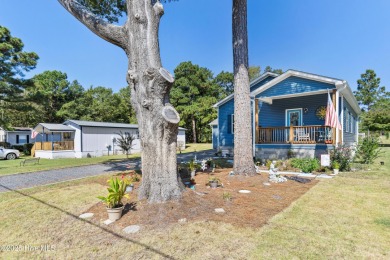 Welcome to this charming 2-bedroom, 2-bath home located just a on Oyster Bay Golf Links in North Carolina - for sale on GolfHomes.com, golf home, golf lot