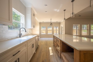 This stunning 5-bedroom, 3-bath brick home offers modern design on The Course At Eagle Mountain in Arkansas - for sale on GolfHomes.com, golf home, golf lot