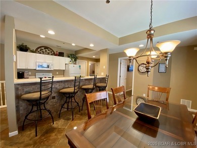 Experience easy lake living in this spacious two-story condo at on Tan-Tar-A Golf Club in Missouri - for sale on GolfHomes.com, golf home, golf lot