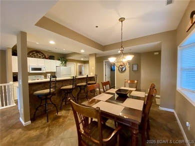 Experience easy lake living in this spacious two-story condo at on Tan-Tar-A Golf Club in Missouri - for sale on GolfHomes.com, golf home, golf lot