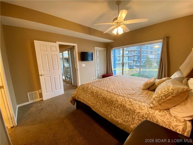 Experience easy lake living in this spacious two-story condo at on Tan-Tar-A Golf Club in Missouri - for sale on GolfHomes.com, golf home, golf lot
