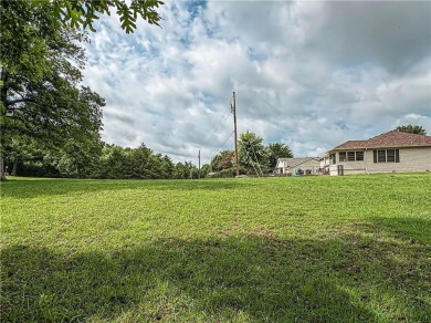 Sitting on 1.55 pristine, park-like acres within walking on Holiday Island Executive Golf Course in Arkansas - for sale on GolfHomes.com, golf home, golf lot