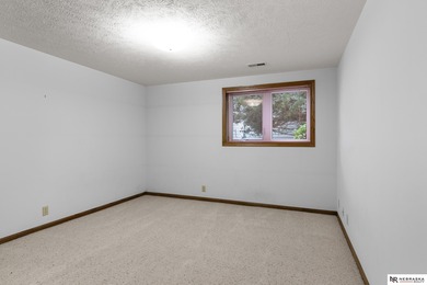 Experience the warmth of a close-knit neighborhood of around 100 on Woodland Hills Golf Course in Nebraska - for sale on GolfHomes.com, golf home, golf lot