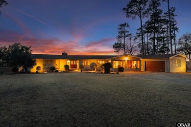 This single-story creek-side home aligns with the surrounding on Duck Woods Country Club in North Carolina - for sale on GolfHomes.com, golf home, golf lot