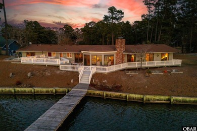 This single-story creek-side home aligns with the surrounding on Duck Woods Country Club in North Carolina - for sale on GolfHomes.com, golf home, golf lot