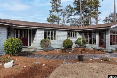 This single-story creek-side home aligns with the surrounding on Duck Woods Country Club in North Carolina - for sale on GolfHomes.com, golf home, golf lot