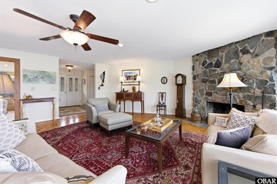 This single-story creek-side home aligns with the surrounding on Duck Woods Country Club in North Carolina - for sale on GolfHomes.com, golf home, golf lot