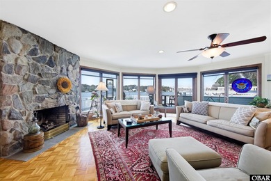 This single-story creek-side home aligns with the surrounding on Duck Woods Country Club in North Carolina - for sale on GolfHomes.com, golf home, golf lot