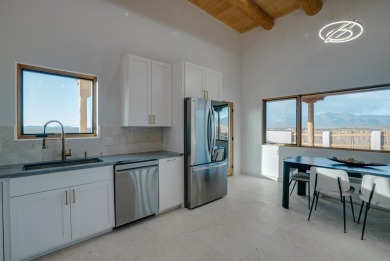 Discover the perfect blend of modern luxury and Southwest charm on Taos Country Club in New Mexico - for sale on GolfHomes.com, golf home, golf lot