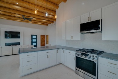 Discover the perfect blend of modern luxury and Southwest charm on Taos Country Club in New Mexico - for sale on GolfHomes.com, golf home, golf lot