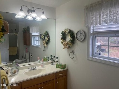 Discover this nicely maintained home on a combined double lot on Lake Tansi Village Country Club in Tennessee - for sale on GolfHomes.com, golf home, golf lot