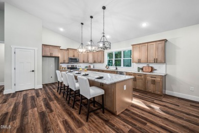 Enjoy one-level living in this beautifully crafted custom ranch on River Golf and Country Club at Lake Royale in North Carolina - for sale on GolfHomes.com, golf home, golf lot
