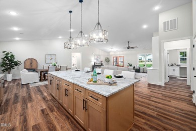 Enjoy one-level living in this beautifully crafted custom ranch on River Golf and Country Club at Lake Royale in North Carolina - for sale on GolfHomes.com, golf home, golf lot