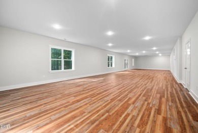 Enjoy one-level living in this beautifully crafted custom ranch on River Golf and Country Club at Lake Royale in North Carolina - for sale on GolfHomes.com, golf home, golf lot
